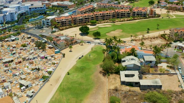 SAN JOSE DEL CABO BCS MEXICO-2021: Golf Cart Moving on Sandy Path Near Housing