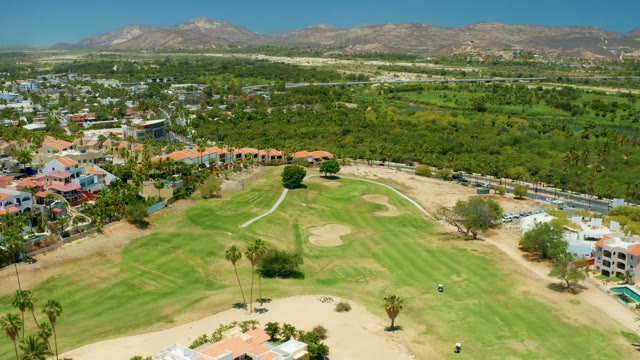 SAN JOSE DEL CABO BCS MEXICO-2021: Golf Course with Residential Buildings and Mountain Backdrop