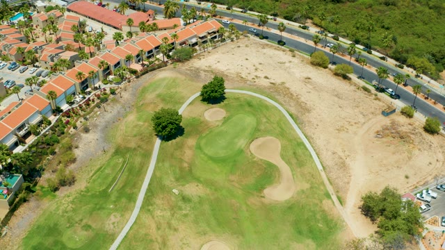 SAN JOSE DEL CABO BCS MEXICO-2021: Golf Course and Road with Moving Vehicles