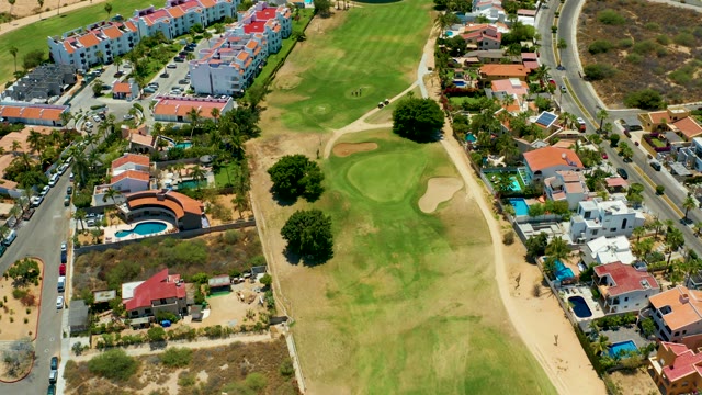SAN JOSE DEL CABO BCS MEXICO-2021: Golf Course with Residential Buildings and Moving Traffic
