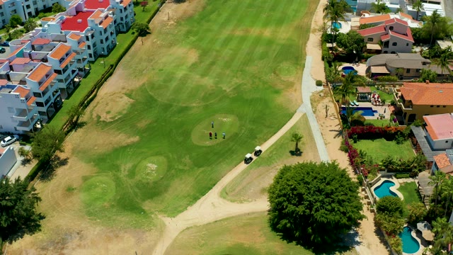 SAN JOSE DEL CABO BCS MEXICO-2021: Golfers Moving on a Residential Golf Course