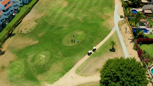SAN JOSE DEL CABO BCS MEXICO-2021: Golfers and Golf Cart Moving on a Course