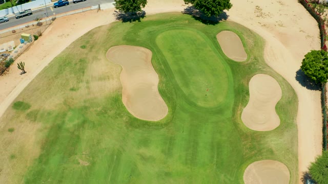 SAN JOSE DEL CABO BCS MEXICO-2021: Golf Ball Rolling on Green with Sand Traps