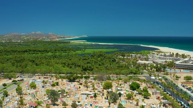 SAN JOSE DEL CABO BCS MEXICO-2021: Beachside Parking Lot with Umbrellas and Moving Traffic