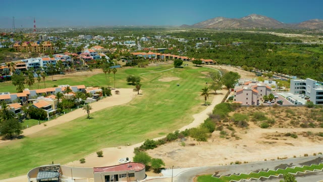 SAN JOSE DEL CABO BCS MEXICO-2021: Golf Cart Moving Across a Golf Course Green