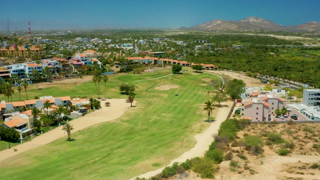 SAN JOSE DEL CABO BCS MEXICO-2021: Golf Course Surrounded by Residential Buildings and Palm Trees