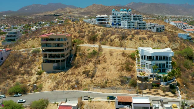 SAN JOSE DEL CABO BCS MEXICO-2021: Hillside Residential Area with Moving Vehicles