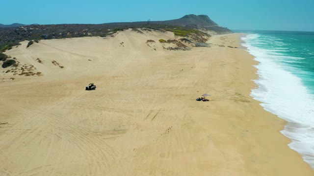 LA LAGUNA BEACH LOS CABOS MEXICO-2021: ATVs Moving Across Sandy Beach Dunes