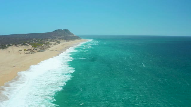 LA LAGUNA BEACH LOS CABOS MEXICO-2021: Ocean Waves Rolling Onto Sandy Beach