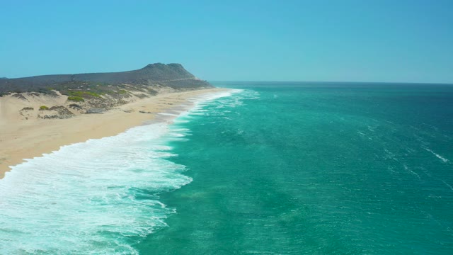 LA LAGUNA BEACH LOS CABOS MEXICO-2021: Waves Rolling Onto Sandy Shore