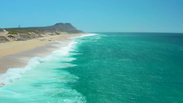 LA LAGUNA BEACH LOS CABOS MEXICO-2021: Waves Crashing on Sandy Shore From Above