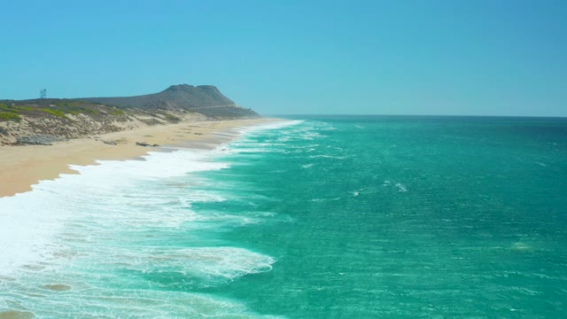 LA LAGUNA BEACH LOS CABOS MEXICO-2021: Ocean Waves Rolling Onto Sandy Beach