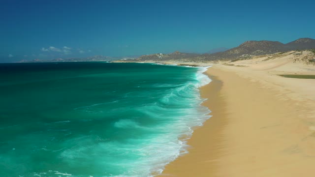 LA LAGUNA BEACH LOS CABOS MEXICO-2021: Waves Rolling Onto Sandy Shore