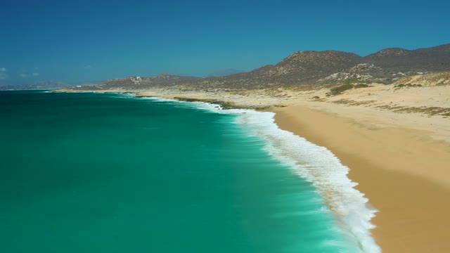 LA LAGUNA BEACH LOS CABOS MEXICO-2021: Gentle Ocean Waves Lapping Sandy Shore