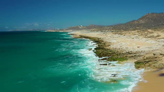 LA LAGUNA BEACH LOS CABOS MEXICO-2021: Waves Crashing on Rocky Coastline