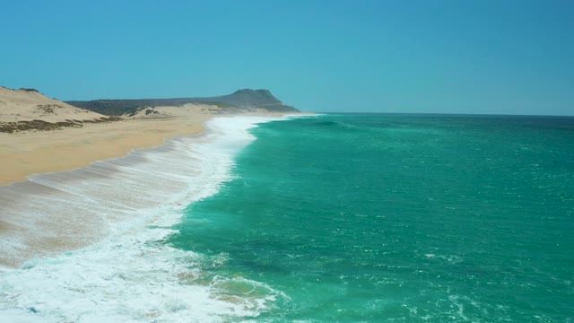 LA LAGUNA BEACH LOS CABOS MEXICO-2021: Waves Rolling Onto Sandy Shore From Aerial Perspective