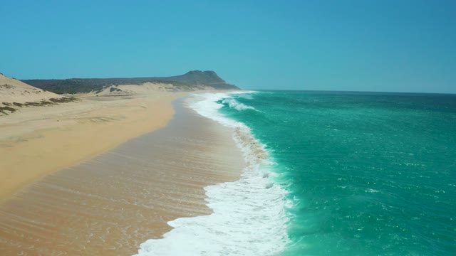 LA LAGUNA BEACH LOS CABOS MEXICO-2021: Sandy Beach with Rolling Ocean Waves