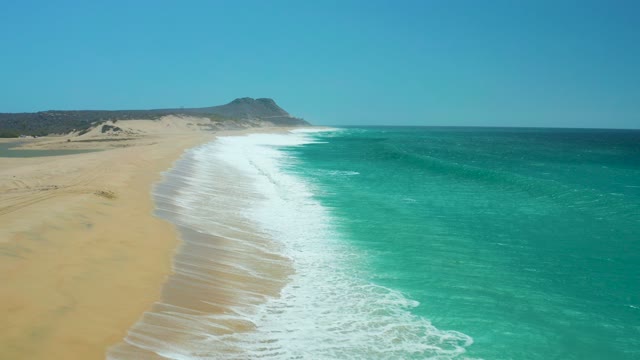 LA LAGUNA BEACH LOS CABOS MEXICO-2021: Waves Rolling Onto Sandy Beach Shoreline