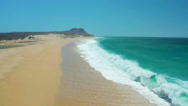 LA LAGUNA BEACH LOS CABOS MEXICO-2021: Aerial View of Waves Rolling Onto Sandy Beach