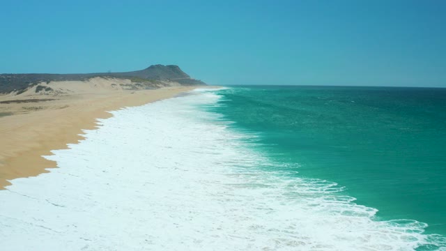 LA LAGUNA BEACH LOS CABOS MEXICO-2021: Waves Rolling Onto Sandy Beach From Above