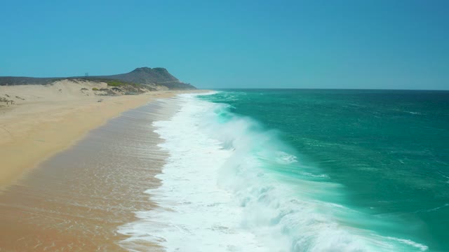 LA LAGUNA BEACH LOS CABOS MEXICO-2021: Waves Crashing Onto Sandy Shore From Aerial
