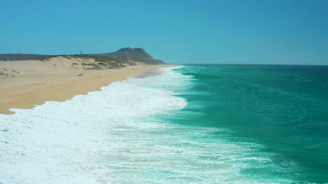 LA LAGUNA BEACH LOS CABOS MEXICO-2021: Waves Advancing on Sandy Shore
