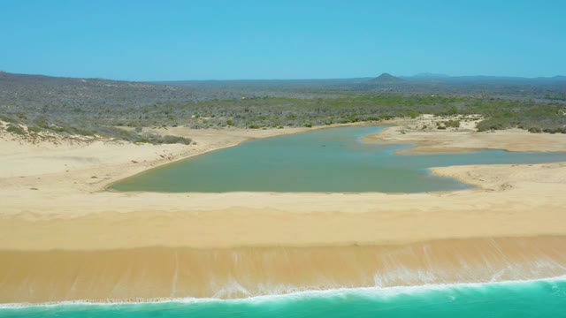 LA LAGUNA BEACH LOS CABOS MEXICO-2021: Sandy Beach Between Lagoon and Ocean Waves