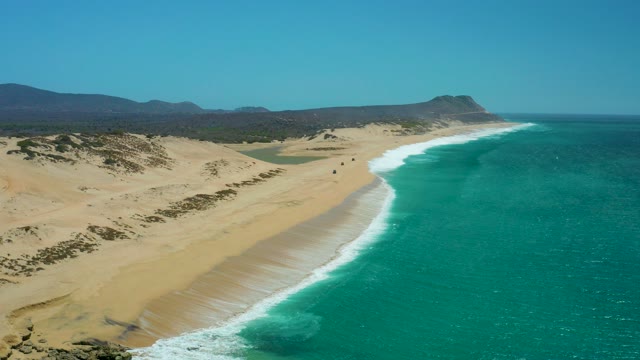 LA LAGUNA BEACH LOS CABOS MEXICO-2021: Sandy Dunes Meeting Turquoise Ocean Waves