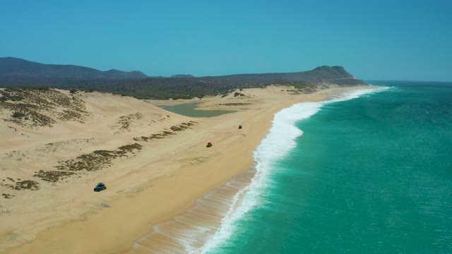 LA LAGUNA BEACH LOS CABOS MEXICO-2021: 4x4 Vehicle Traveling on Sandy Beach with Dunes