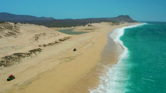 LA LAGUNA BEACH LOS CABOS MEXICO-2021: 4x4 Vehicles Driving on Sandy Beach with Dunes