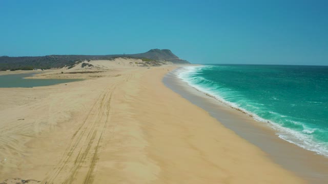 LA LAGUNA BEACH LOS CABOS MEXICO-2021: Sandy Beach and Turquoise Ocean Waves