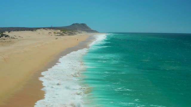 LA LAGUNA BEACH LOS CABOS MEXICO-2021: Waves Advancing on a Sandy Beach