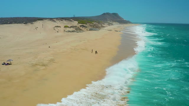 LA LAGUNA BEACH LOS CABOS MEXICO-2021: Waves Rolling Onto Sandy Beach with Dunes