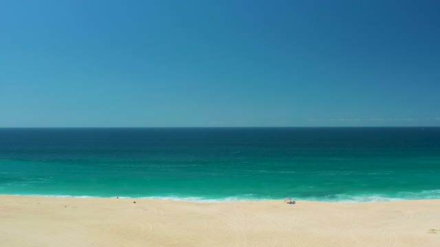 LA LAGUNA BEACH LOS CABOS MEXICO-2021: Sandy Beach with Ocean Waves and People