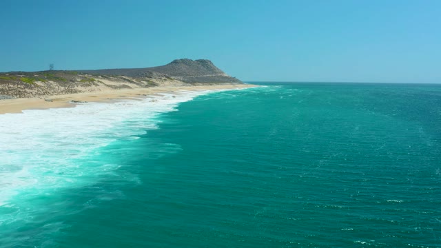 LA LAGUNA BEACH LOS CABOS MEXICO-2021: Waves Breaking on a Sandy Shore