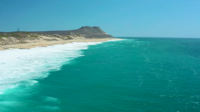 LA LAGUNA BEACH LOS CABOS MEXICO-2021: Waves Crashing on Sandy Beach Coastline