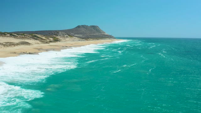 LA LAGUNA BEACH LOS CABOS MEXICO-2021: Waves Breaking on Sandy Beach Coastline