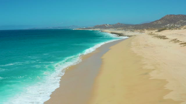 LA LAGUNA BEACH LOS CABOS MEXICO-2021: Gentle Ocean Waves Lapping Sandy Shore