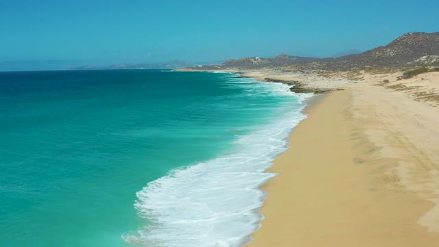 LA LAGUNA BEACH LOS CABOS MEXICO-2021: Coastal Waves Rolling Onto Sandy Shore