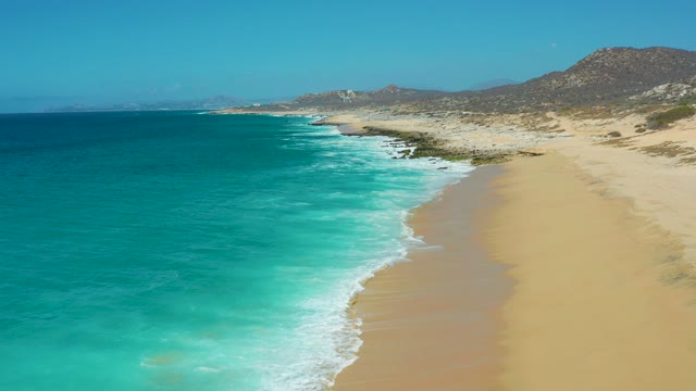 LA LAGUNA BEACH LOS CABOS MEXICO-2021: Sandy Beach and Turquoise Ocean Waves Along Coastline