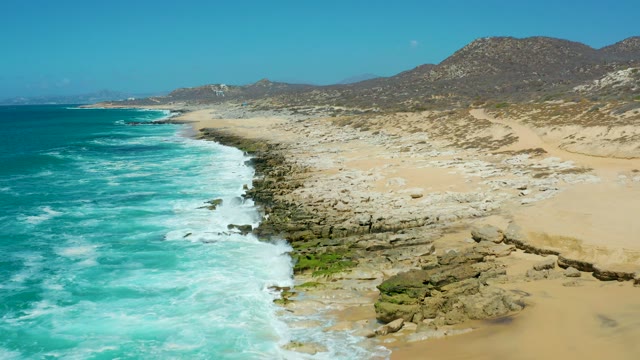 LA LAGUNA BEACH LOS CABOS MEXICO-2021: Coastal Shoreline with Turquoise Waves and Rocky Beach