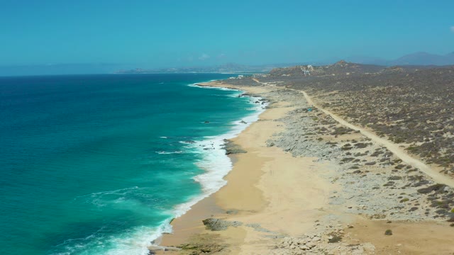 LA LAGUNA BEACH LOS CABOS MEXICO-2021: Car Driving Along Coastal Dirt Road by Ocean Waves