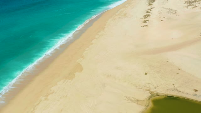 LA LAGUNA BEACH LOS CABOS MEXICO-2021: Waves Breaking on Sandy Beach with Dunes