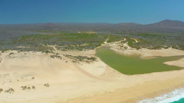 LA LAGUNA BEACH LOS CABOS MEXICO-2021: Lagoon and Sandy Dunes with Ocean Waves