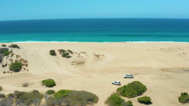 LA LAGUNA BEACH LOS CABOS MEXICO-2021: White SUV Moving Across Coastal Sand Dunes
