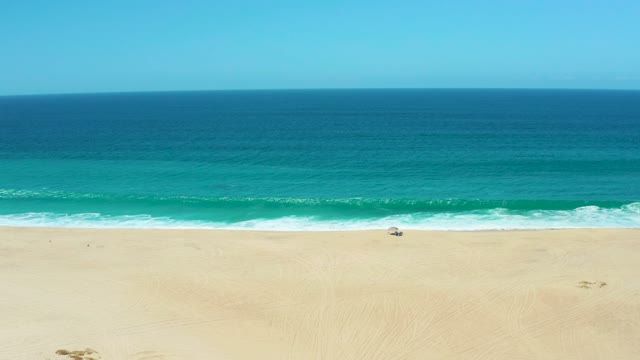 LA LAGUNA BEACH LOS CABOS MEXICO-2021: Ocean Waves Breaking on Sandy Beach