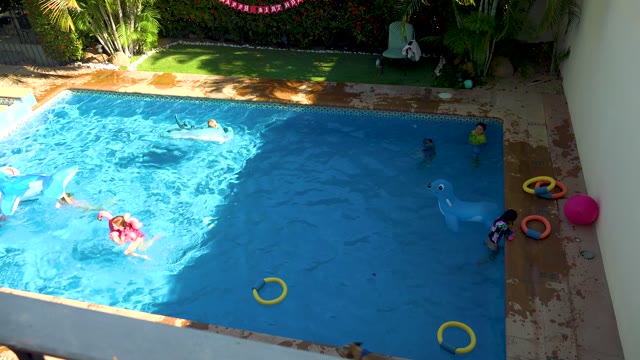 SAN JOSE DEL CABO BCS MEXICO-2020: Children Playing in a Backyard Swimming Pool