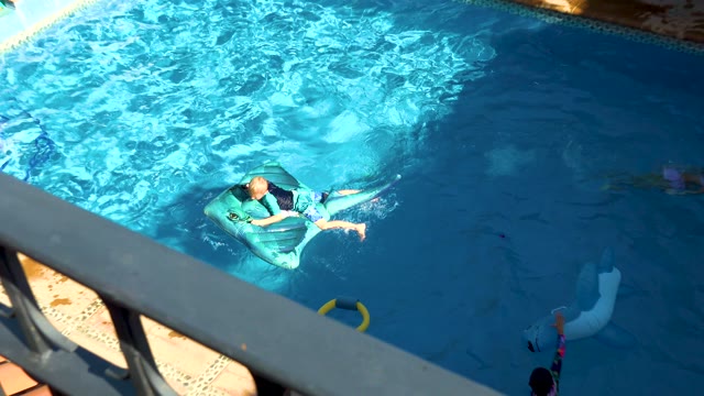 SAN JOSE DEL CABO BCS MEXICO-2020: Children Playing in a Backyard Swimming Pool