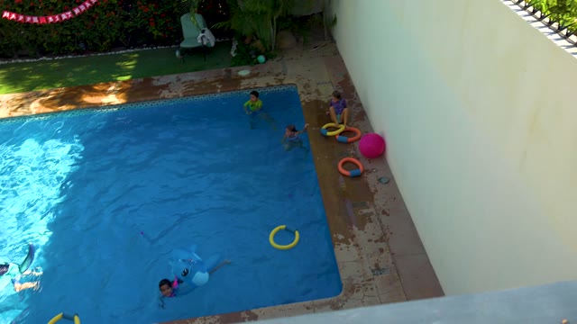 SAN JOSE DEL CABO BCS MEXICO-2020: Children Playing in a Backyard Swimming Pool