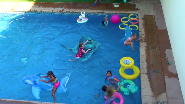 SAN JOSE DEL CABO BCS MEXICO-2020: Children Playing with Inflatable Floats in a Swimming Pool